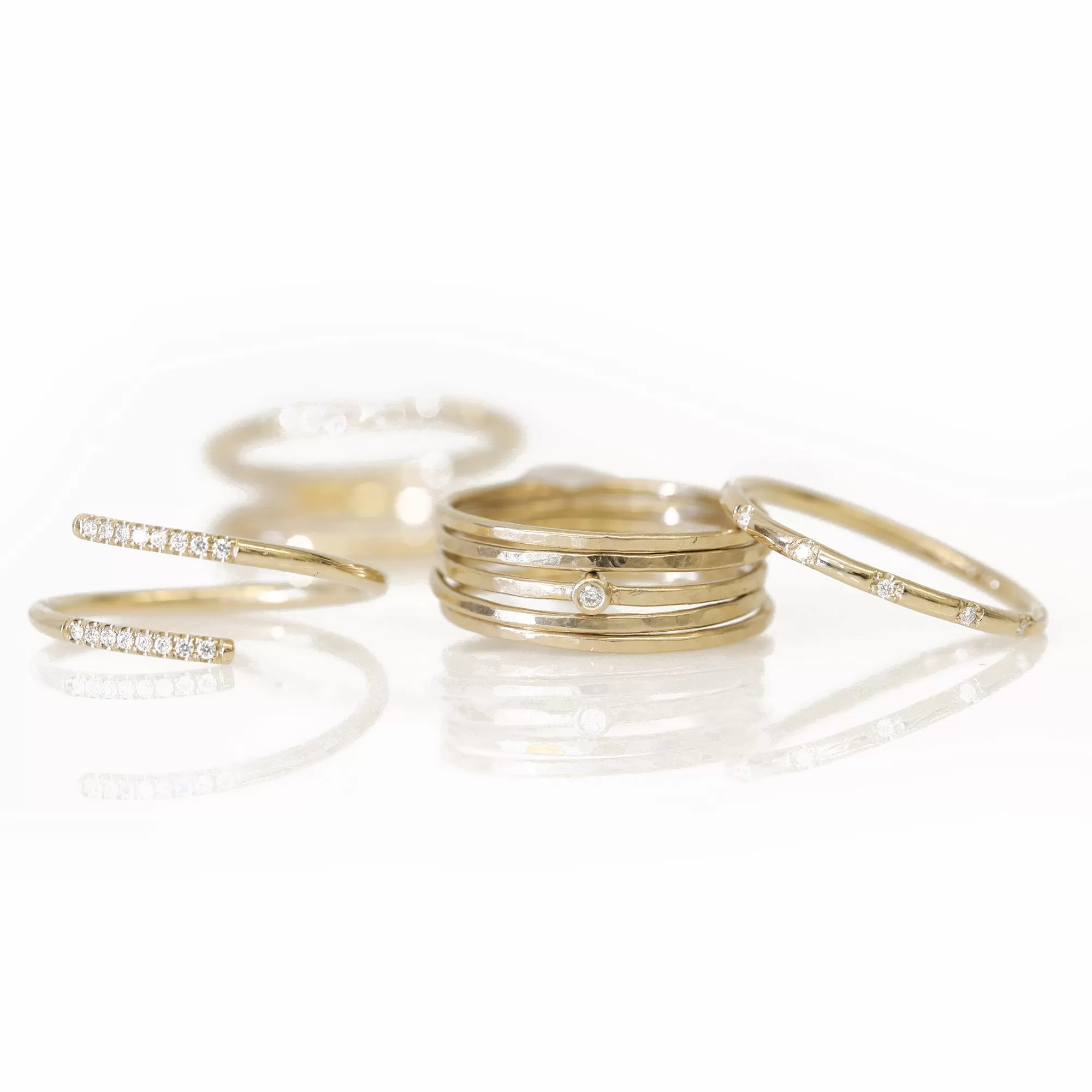 Five Gold Thin Hammered Stacking Rings with Single Diamond